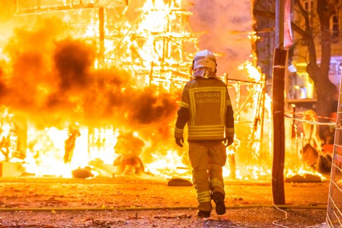 Firefighter with his protective suit working controlling the burning of a Falla during the Valencian fiestas. Investigación atribuye el incendio Eaton a arcos eléctricos en una torre de SCE